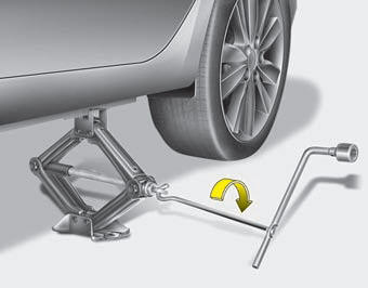 8.Insert the jack handle into the jack and turn it clockwise, raising the vehicle