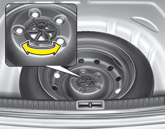 Turn the tire hold-down wing bolt counterclockwise.